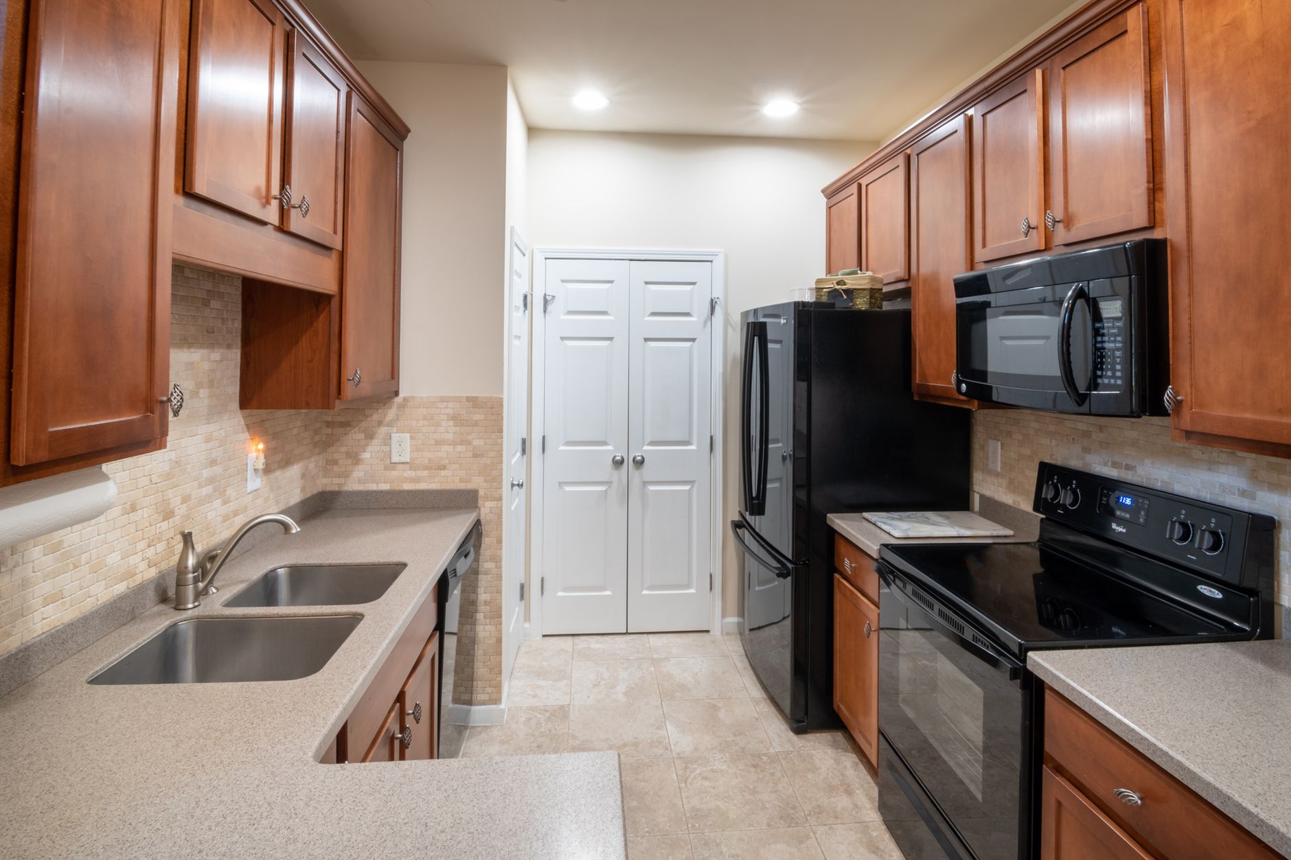 Spacious modern kitchen with wood cabinets, sleek countertops, and stainless steel appliances in Temecula, CA