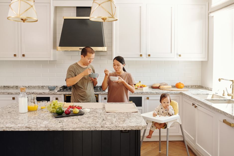 A bright kitchen with a counter and island seating.